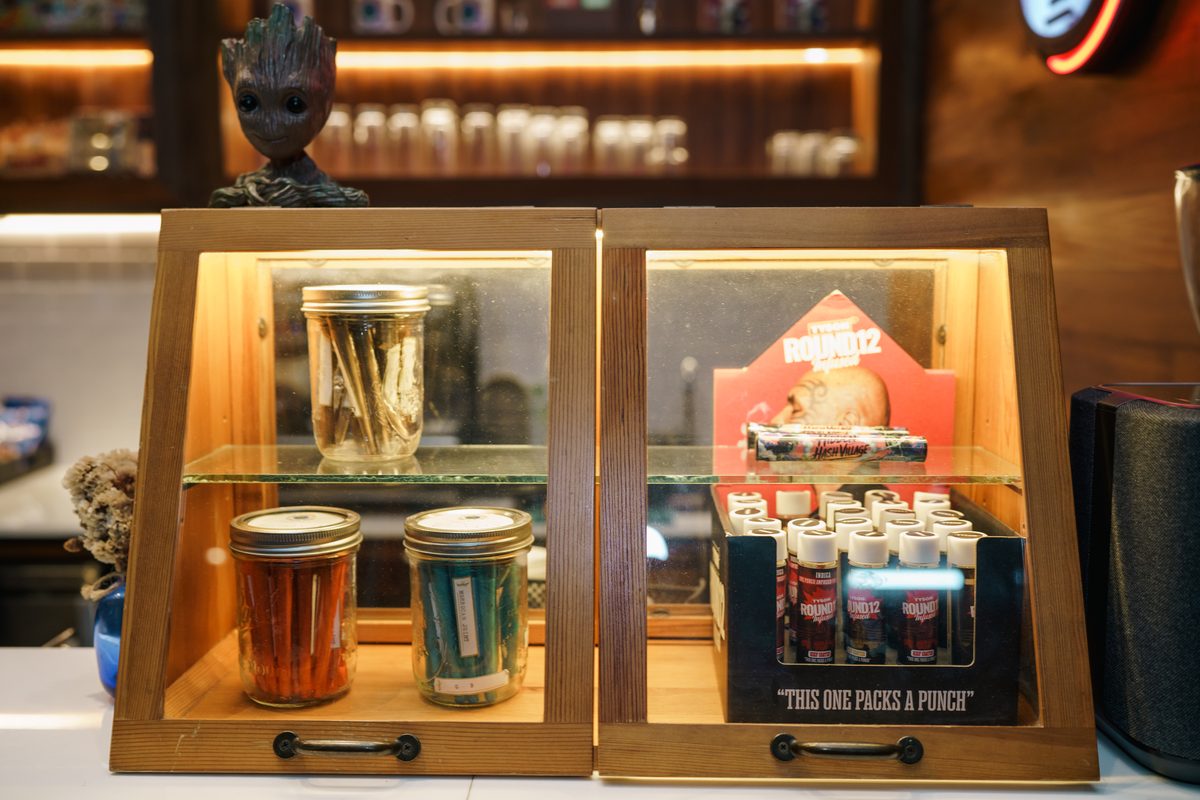 Pre-roll display cases on the counter at The Mantis, Ao Nang