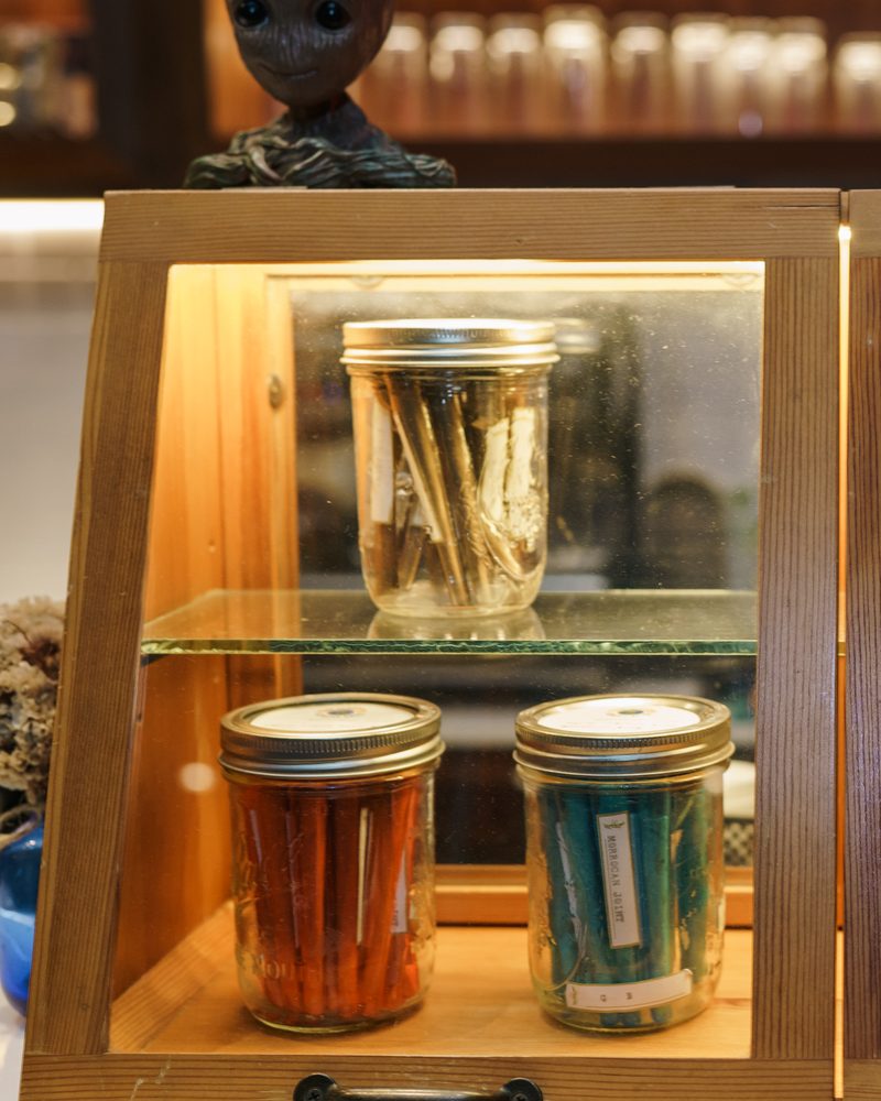 Glass display case with a jar of pre-rolls on the counter at Coffeeshop The Mantis, Ao Nang